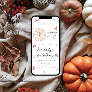 May include: A smartphone displays a fall-themed invitation with the text "Our Little Pumkin is turning one." The invitation includes the name "Kimberly" and the date of her first birthday. The image is surrounded by pumpkins, leaves, and fall foliage.