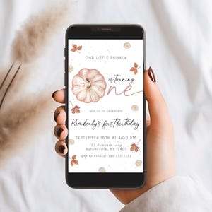 May include: A smartphone displays a digital invitation for a first birthday. The design features a watercolor pumpkin, fall leaves, and the text "Our Little Pumkin is turning one." The invitation includes the name "Kimberly's first birthday" and event details.