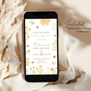 May include: A phone screen mockup showing a honeybee themed first birthday party invitation. The invitation features a honeycomb design, yellow flowers, and bees. The text on the invitation reads "Our little honey is turning one!" and "Join us for a Melania's First Bee Day!" The date and time of the party are listed as "Friday 15 at 2PM". The location is listed as "Space Drive 145, Denver, Florida, 11093".
