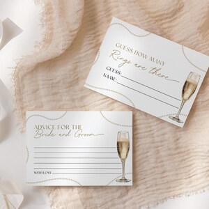 May include: Two white cards with gold accents and a champagne glass illustration. The top card says "Guess how many rings are there" with lines for a guess and name. The bottom card says "Advice for the Bride and Groom" with lines for writing advice.