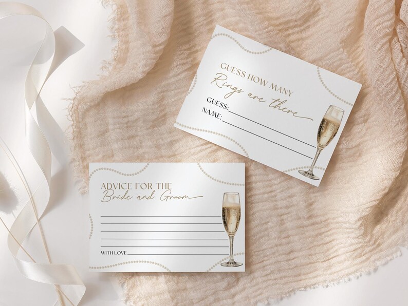 May include: Two white cards with gold accents and a champagne glass illustration. The top card says "Guess how many rings are there" with lines for a guess and name. The bottom card says "Advice for the Bride and Groom" with lines for writing advice.
