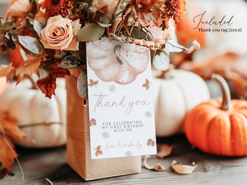 May include: A fall-themed arrangement featuring a bouquet of flowers, pumpkins, and a 'Thank You' tag. The tag has a pumpkin illustration and the text: 'Thank you for celebrating my first birthday with me'. The tag measures 2x3.5 inches.