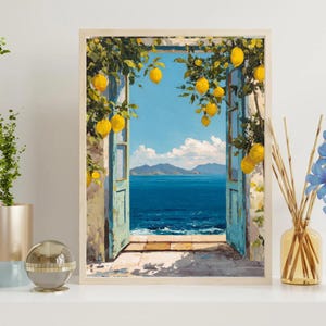 May include: A framed art print shows an open doorway with a view of a blue sea and sky. Lemon trees with yellow fruit hang around the doorway. The artwork is in a light wooden frame.