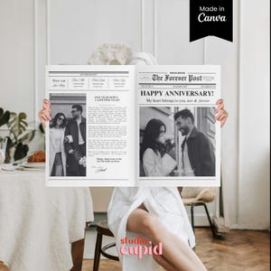 May include: A black and white newspaper-style print with the headline "Happy Anniversary!" and the text "My heart belongs to you, now & forever." The print features two black and white photos of a couple. The words "Made in Canva" are in the top right corner.