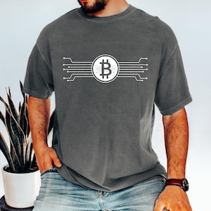 May include: A dark gray t-shirt with a white Bitcoin symbol and circuit board design.