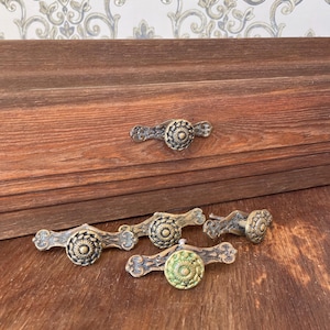 May include: A weathered wooden sign displaying the words "Welcome to our home" in white. The sign has a distressed appearance, suggesting a vintage style, and is suitable for a front door or hallway.