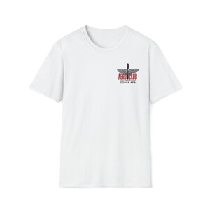 May include: White crew neck t-shirt with a small logo on the upper left chest. The logo features a propeller design with the words "AERO CLUB" in red and black, and "DOVER AFB" below it. The shirt is a classic, casual style.