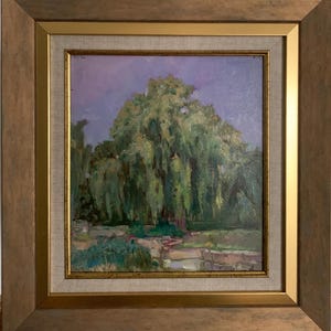 May include: Oil painting of a weeping willow tree with green foliage under a purple sky. The artwork is framed in a gold-colored frame with a light-colored inner border. The painting depicts a landscape scene.
