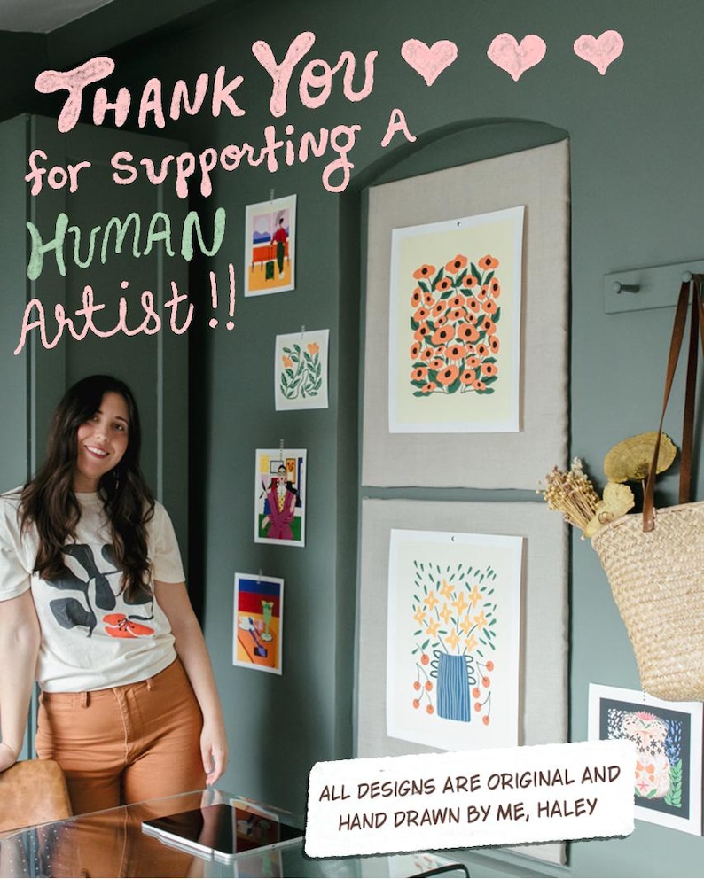 May include: A woman stands in front of a wall adorned with original art prints. The prints feature floral and abstract designs in various sizes and colors. Text above reads "Thank You for supporting a Human Artist!!" and "All designs are original and hand drawn by me, Haley."