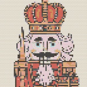 Op de afbeelding: Een gepixeld beeld van een notenkrakersoldaat. De notenkraker draagt een rode jas, een groene broek en een hoge kroon. Hij houdt een wit voorwerp in de ene hand en een doos in de andere.