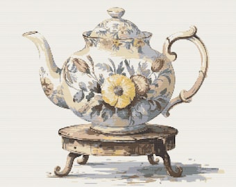 May include: A ceramic teapot featuring a floral pattern with yellow and blue blossoms on a cream background, complete with a matching lid and curved handle. The teapot rests upon a small, round, four-legged wooden stand with a weathered finish.