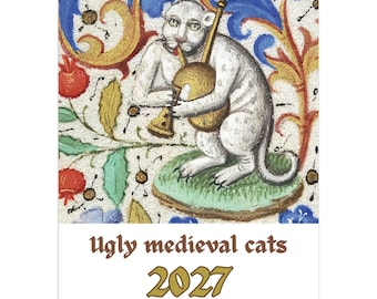 Op de afbeelding: Een 12-maandenkalender voor 2027 met de titel Ugly medieval cats. De omslag toont een middeleeuwse illustratie van een witte kat die een gouden blaasinstrument bespeelt, tegen een decoratieve achtergrond van rode granaatappels en blauw blad.