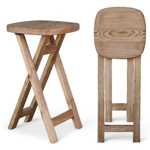 May include: Two wooden folding stools with a natural wood finish. The stools are made of solid wood and have a simple, rustic design.