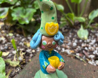 Garden gnome little figure  with her favorite tulip flower to brighten your desk, indoor plants, garden or patio. One of a kind!