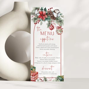 May include: A vertical menu card featuring a red arched border, decorated with watercolor illustrations of poinsettias, pine branches, cotton bolls, pinecones, and ornaments. The text reads: The MENU appetizer, entree, and dessert with food items.