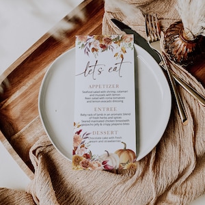 May include: A fall-themed menu card with a floral design and pumpkins. The menu lists "Let's Eat" with appetizers, entree, and dessert options.