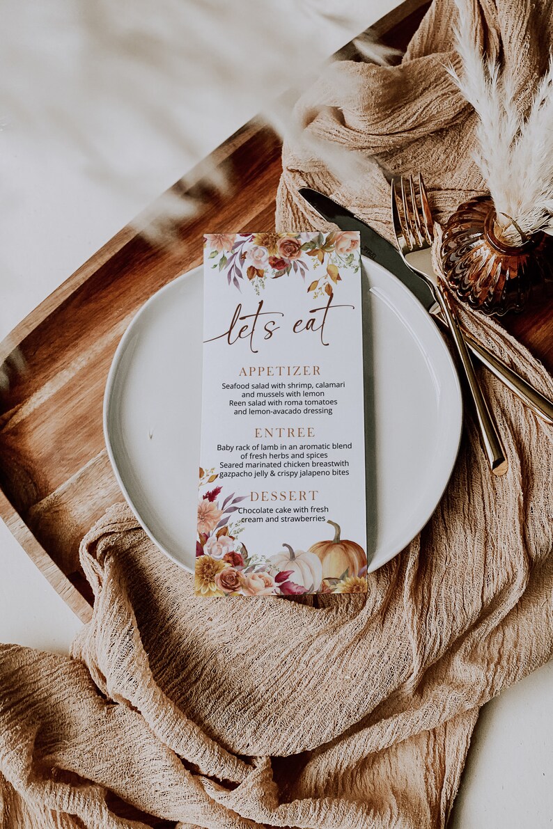 May include: A fall-themed menu card with a floral design and pumpkins. The menu lists "Let's Eat" with appetizers, entree, and dessert options.
