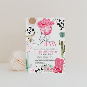 May include: A party invitation with a pink cowboy hat, boots, and cactus illustrations. The invitation reads "Yee Haw" and includes the text "Saddle up and join us for a Amanda Paterson Turning Five". The invitation also includes the date, time, and location.