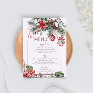 May include: A rectangular menu card featuring a red arched border, watercolor illustrations of poinsettias, pine branches, pinecones, cotton bolls, and Christmas ornaments. The text reads The Menu, appetizer, entree, and dessert with food items listed.
