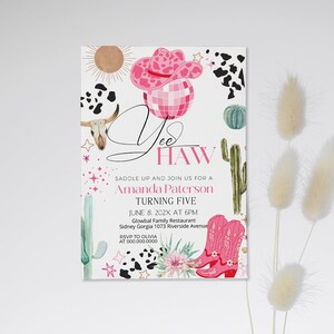 May include: A party invitation with a cowgirl theme. The design features a pink cowboy hat, disco ball, and boots. The text reads "Yee Haw" and includes event details for Amanda Paterson's fifth birthday.