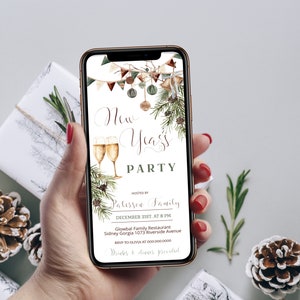 May include: A smartphone displays a New Year's Party invitation. The design features champagne glasses, festive greenery, and decorative elements. The invitation includes the text "New Year's Party" and event details.