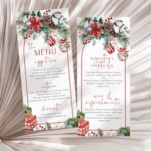 May include: Two vertical menu cards featuring watercolor illustrations of pine branches, red poinsettias, cotton bolls, pinecones, and ornaments. The text includes "the MENU", "appetizer", "entree", "dessert", "signature cocktails", and "wine & refreshments".