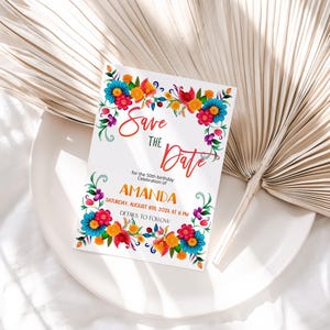 May include: Save the Date card with a colorful floral border. The card is white with red, orange, yellow, blue, and green flowers. The text on the card reads "Save the Date" for the 50th birthday celebration of Amanda. The date and time of the event are listed as Saturday, August 8th, 2024 at 6 PM. The text "Details to follow" is also included.