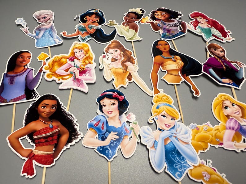 May include: A set of 12 princess themed cake toppers. The toppers feature various Disney princesses, including Snow White, Cinderella, Ariel, Belle, and Mulan. Each topper is printed on cardstock and has a wooden stick attached to the back.