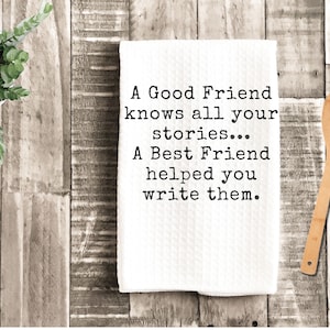 May include: White kitchen towel with the text "A Good Friend knows all your stories... A Best Friend helped you write them." A wooden spoon and a potted plant are also in the image.