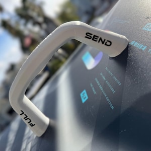 May include: White plastic handle with the word "FULL" printed on one side and "SEND" printed on the other side. The handle is attached to a dark gray surface with white text.