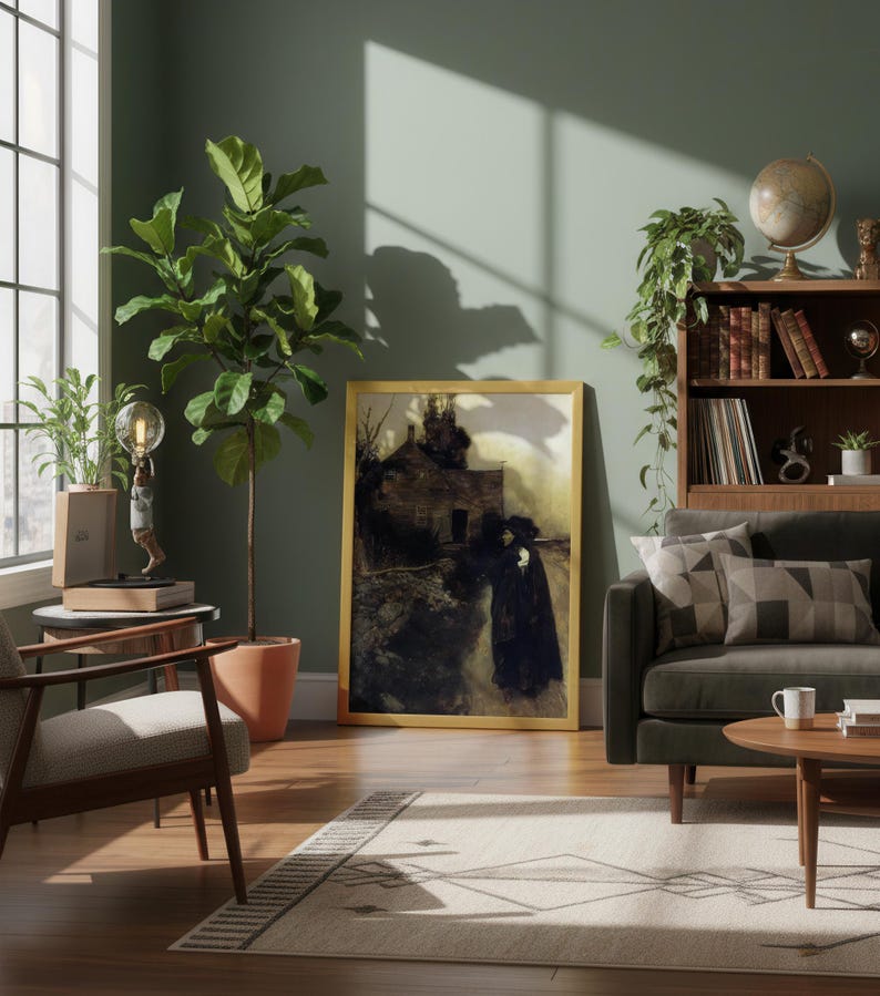 May include: A living room scene with a framed artwork, a sofa, and a rug. The artwork features a dark, moody painting in a gold frame. A large potted plant and a globe sit near a window. The room has a warm, inviting atmosphere.