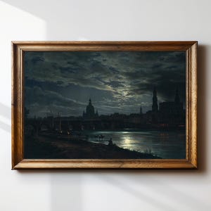 May include: A framed landscape painting depicting a nighttime cityscape with a river, bridge, and buildings under a cloudy sky. The painting is in a wooden frame.