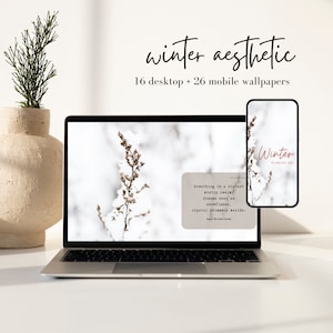 May include: A laptop and smartphone display winter-themed wallpapers. The laptop shows a snowy scene with text, while the phone displays "Winter Wonderland." The words "winter aesthetic" and "16 desktop + 26 mobile wallpapers" are also visible.
