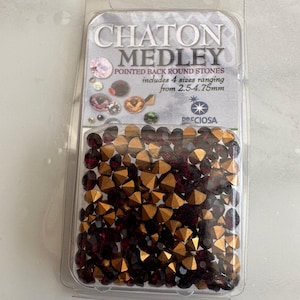 May include: A pack of Chaton Medley pointed back round stones. The pack includes 4 sizes ranging from 2.5-4.75mm. The stones are a mix of burgundy and gold.