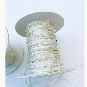 Hilo de cristal Swarovski® de 5 metros, 3 mm, cristales bicónicos AB, ref.: 59000 craft