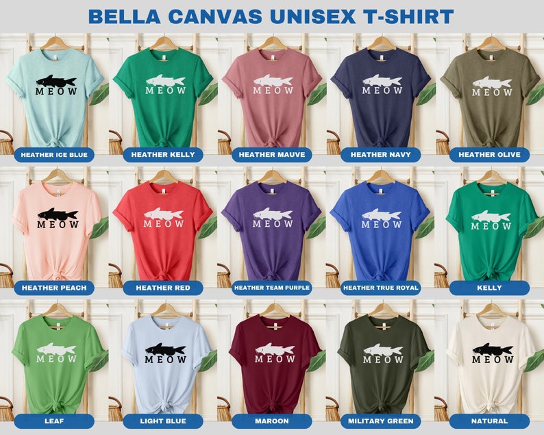 May include: A collection of Bella Canvas unisex t-shirts in various colors featuring a white silhouette of a fish with the word "MEOW" printed below. The colors include Heather Ice Blue, Heather Kelly, Heather Mauve, Heather Navy, Heather Olive, Heather Peach, Heather Red, Heather Team Purple, Heather True Royal, Kelly, Leaf, Light Blue, Maroon, Military Green, and Natural.