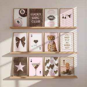 May include: A set of framed art prints with diverse designs. Prints include an 8-ball, lips, a bow, playing cards, a cheetah, and text that reads "Lucky Girl Club" and "What if it all works out?" The color scheme incorporates pink, brown, and black.
