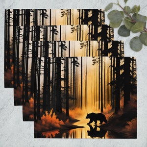 May include: A black bear silhouette walks through a forest with tall trees and a golden sunset in the background. The bear is walking towards a small stream of water. The forest is filled with tall trees and the ground is covered in fallen leaves.
