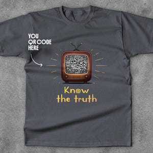 May include: Dark grey t-shirt with a retro television graphic displaying a QR code and the words "Know the truth." The shirt also includes the text "YOU QR CODE HERE."