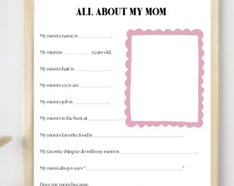 May include: A framed white paper with the text "ALL ABOUT MY MOM" and fill-in-the-blank prompts. Includes a pink scalloped frame for a photo and the text "Happy Mother's Day!"