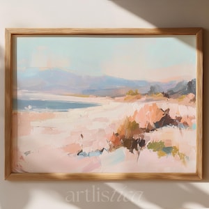 May include: Abstract landscape painting in a light wooden frame. The artwork features a beach scene with soft pastel colors, including pink, blue, and peach. The painting has visible brushstrokes and a textured appearance.