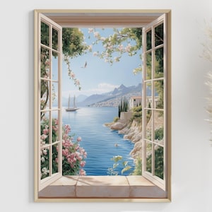 Puede incluir: Una impresión enmarcada representa una escena costera vista a través de una ventana abierta. La obra de arte muestra un velero sobre agua azul, montañas y edificios. Flores rosas y vegetación enmarcan la ventana, con hierba de la pampa a la derecha.
