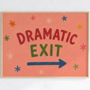 Puede incluir: Una lámina decorativa rectangular en un marco de madera clara con fondo rosa coral. El texto DRAMATIC EXIT está impreso en letras rojas y verdes. Una flecha azul oscuro apunta a la derecha, rodeada de pequeñas estrellas coloridas.