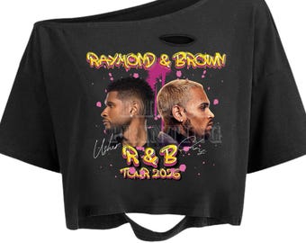 May include: Black crop top with a distressed neckline and hem. The shirt features a graphic of two men's faces and the text "RAYMOND & BROWN" in yellow and pink, along with "R&B TOUR 2026".