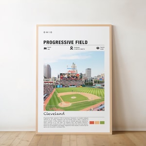 Op de afbeelding: Een ingelijste poster met Progressive Field in Cleveland, Ohio. De afbeelding toont het honkbalstadion met een groen veld, zitplaatsen en een stadsgezicht op de achtergrond. Tekst bevat "Progressive Field" en "Cleveland."