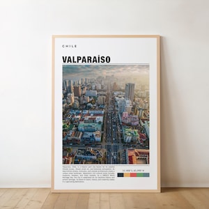 May include: A framed poster featuring an aerial view of Valparaíso, Chile, with the city's name in bold letters. The poster includes text describing the city's colorful atmosphere and UNESCO World Heritage status. The frame is a light brown color.
