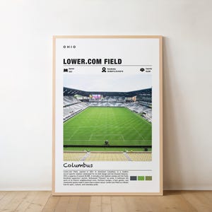 May include: A black and white photo of Lower.com Field, a soccer stadium in Columbus, Ohio. The stadium is surrounded by green grass and has a capacity of 20,000.
