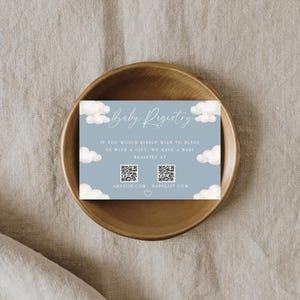 May include: A blue and white baby registry card with clouds and the text "Baby Registry".  The card includes QR codes for Amazon and Babylist.