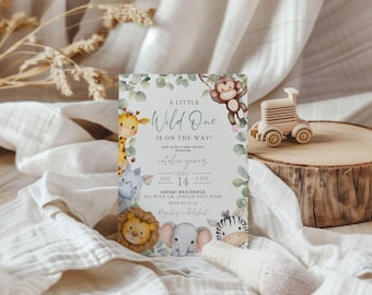 May include: A baby shower invitation with a jungle theme. The invitation features a watercolor illustration of a giraffe, monkey, lion, elephant, and zebra. The text on the invitation reads "A Little Wild One is on the Way!" and includes the date, time, and location of the shower.