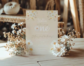 May include: A white and yellow floral birthday invitation for a first birthday party. The invitation says "Stella is turning one" and includes the date, time, and location of the party.